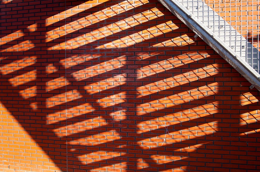 shadows of stairs on brick wall